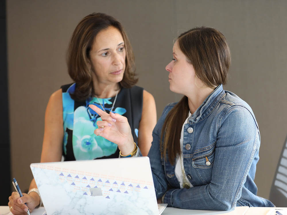 Denise talking with a student